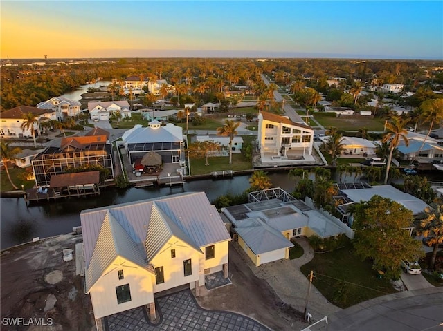 aerial view at dusk with a water view