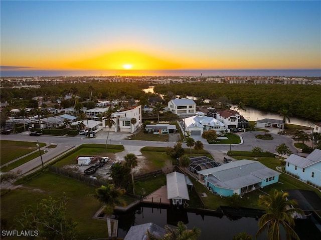 aerial view at dusk with a water view