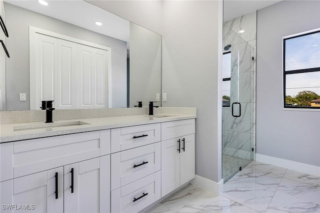 bathroom with vanity and a shower with shower door