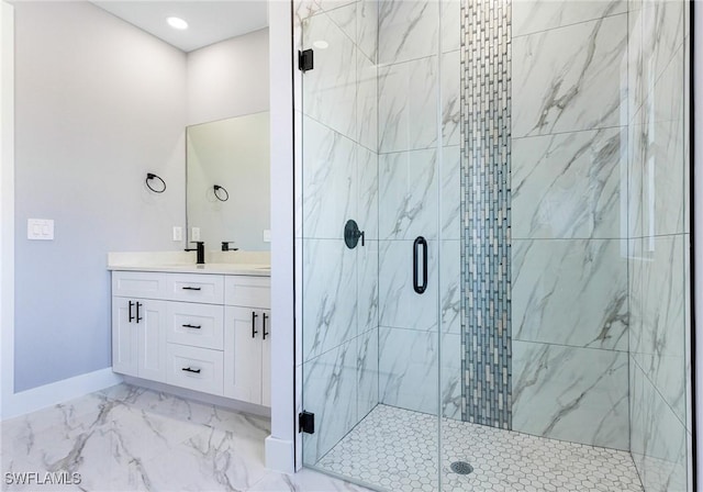 bathroom featuring vanity and a shower with shower door