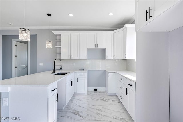 kitchen with pendant lighting, sink, crown molding, white cabinets, and decorative backsplash