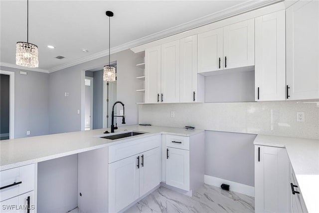 kitchen featuring sink, decorative light fixtures, ornamental molding, and white cabinets