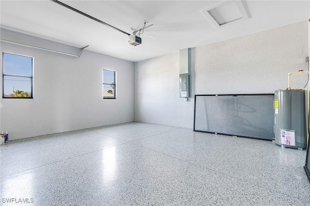 garage with water heater, a garage door opener, and electric panel