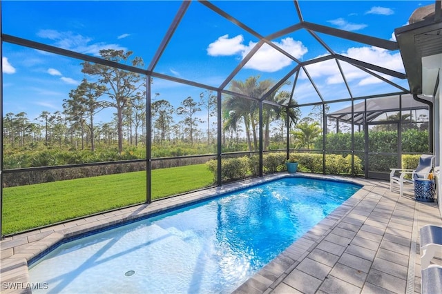 view of swimming pool with a yard, a lanai, and a patio area