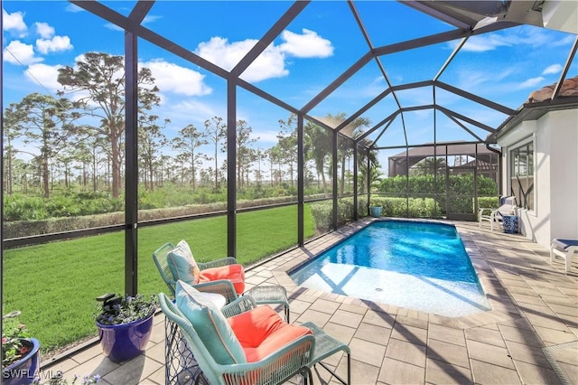 view of pool featuring a yard, glass enclosure, and a patio area