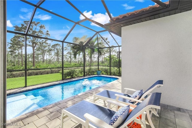 view of swimming pool featuring a patio and a lanai