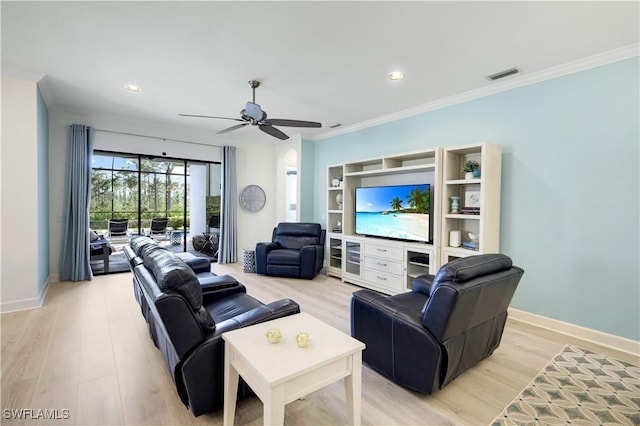 living room with crown molding, ceiling fan, and light wood-type flooring