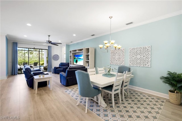 dining space featuring crown molding, ceiling fan with notable chandelier, and light hardwood / wood-style floors