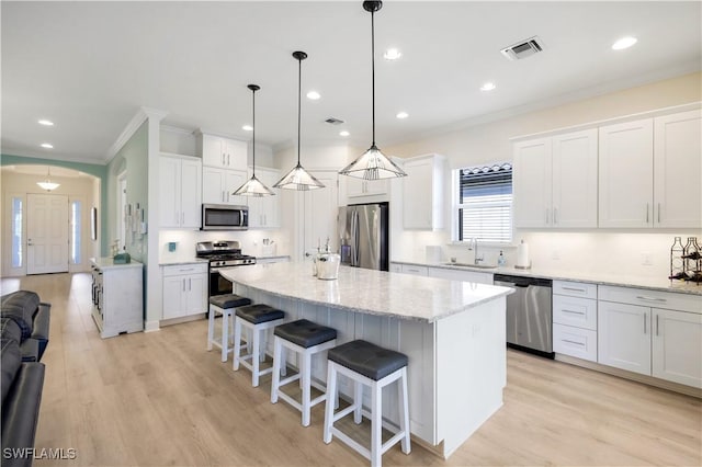 kitchen with white cabinetry, stainless steel appliances, and sink