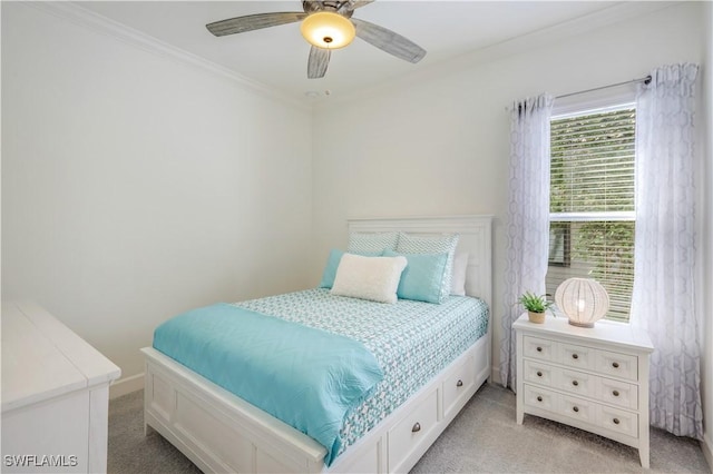 carpeted bedroom with crown molding and ceiling fan