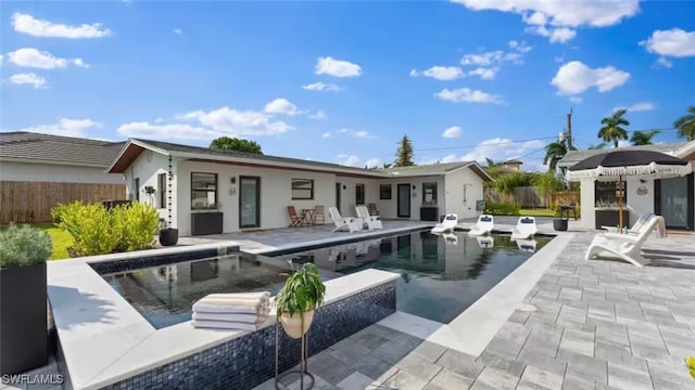 view of pool with an outbuilding and a patio area