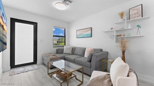 living area with wood finished floors and visible vents