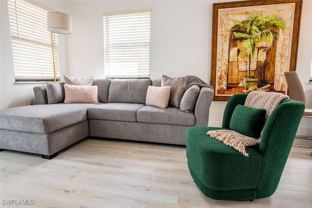 living area with plenty of natural light and wood finished floors