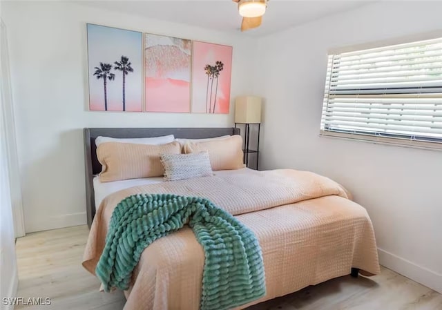 bedroom with baseboards and wood finished floors