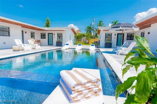 view of swimming pool featuring a fenced in pool and a patio