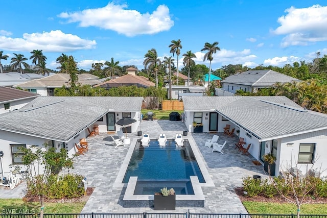 view of swimming pool with a fenced backyard, a residential view, a fenced in pool, and a patio