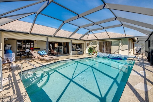 view of swimming pool with a lanai and a patio area