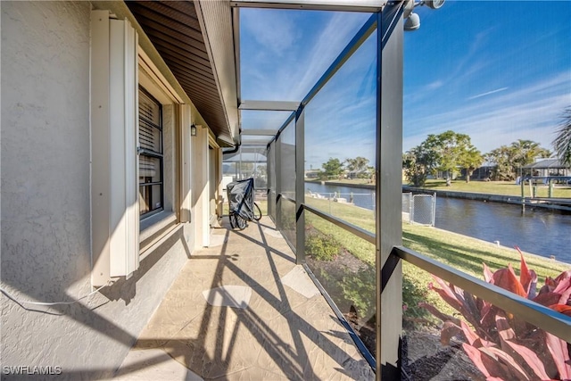 sunroom / solarium featuring a water view