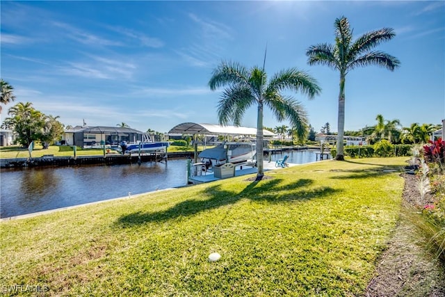 view of dock with a water view and a yard