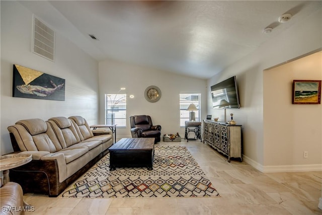 living room featuring lofted ceiling