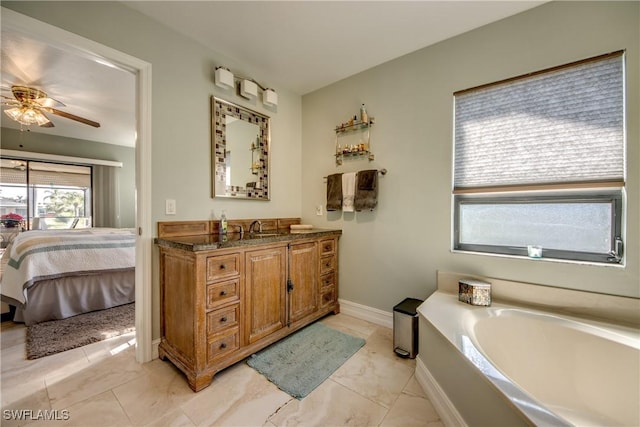 bathroom featuring vanity, a tub, and ceiling fan