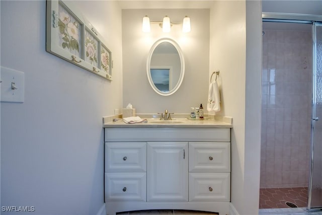 bathroom featuring vanity and a shower with shower door