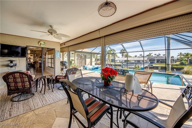 sunroom featuring ceiling fan