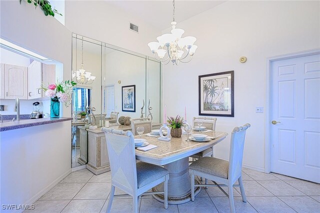 tiled dining room with high vaulted ceiling and a notable chandelier