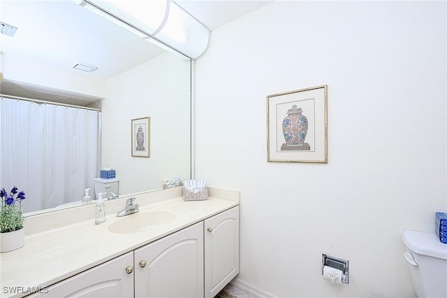 bathroom with vanity and toilet