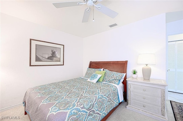 carpeted bedroom with a closet and ceiling fan