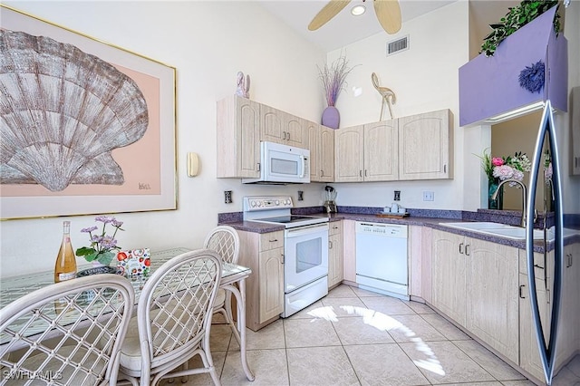 kitchen with high vaulted ceiling, sink, light tile patterned floors, ceiling fan, and white appliances