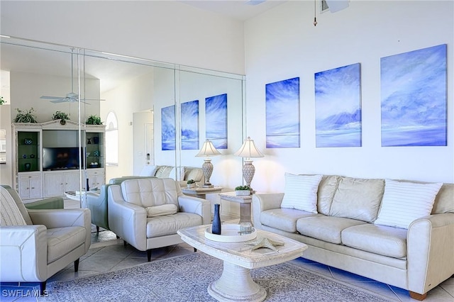 tiled living room featuring ceiling fan