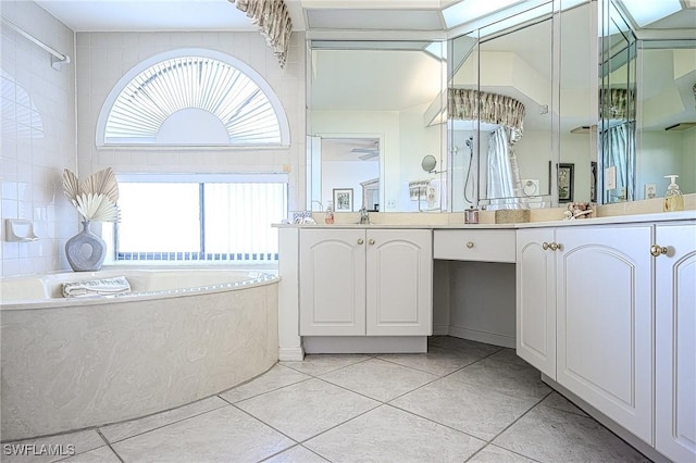 bathroom featuring tile patterned flooring, vanity, and a washtub