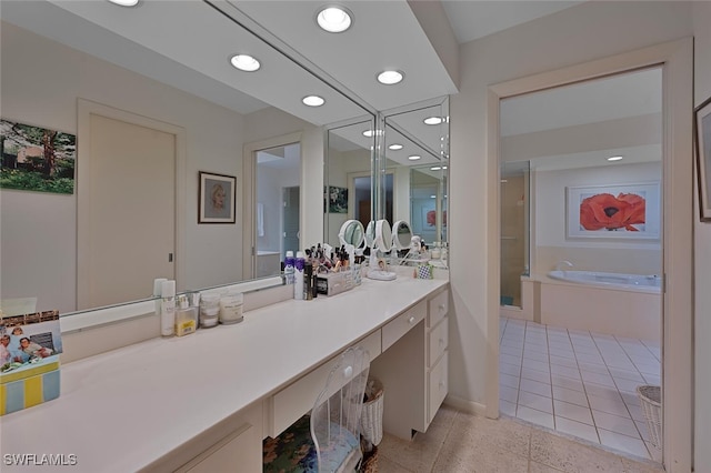 bathroom with tile patterned flooring, vanity, and a bathtub