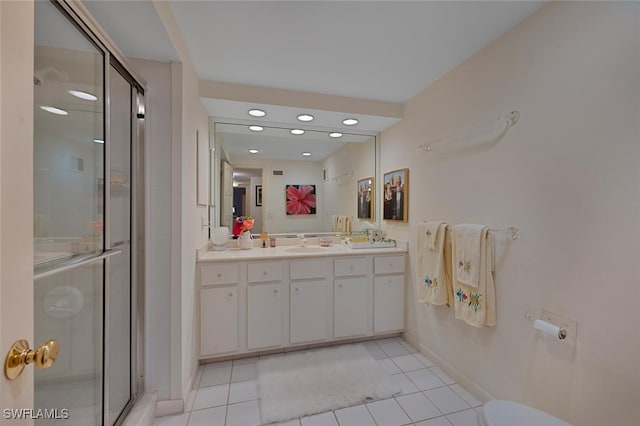 bathroom featuring vanity, tile patterned flooring, and a shower with door