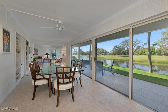 sunroom / solarium featuring a water view and ceiling fan