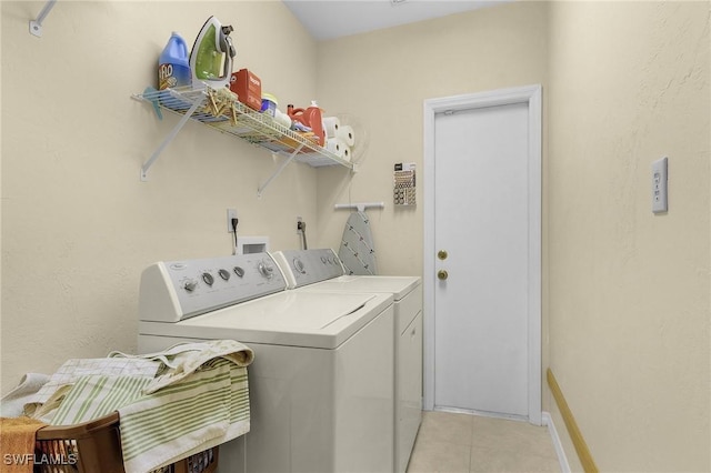 laundry room featuring light tile patterned flooring and separate washer and dryer