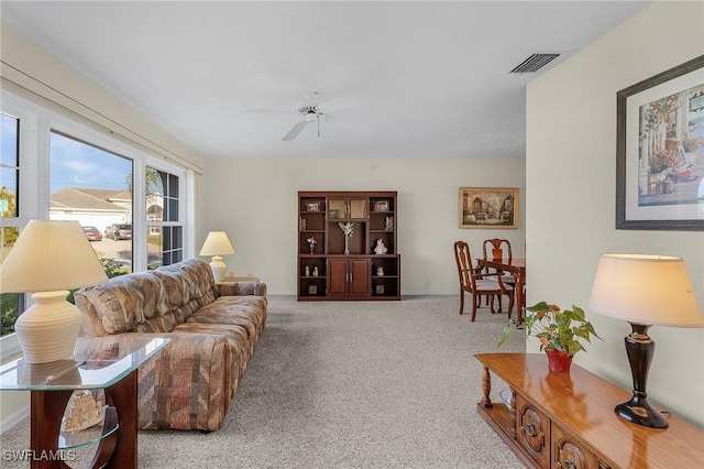 living room featuring light colored carpet and ceiling fan