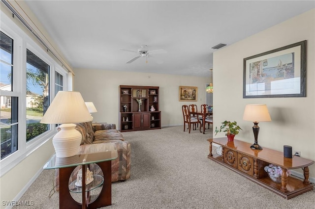 carpeted living room featuring ceiling fan