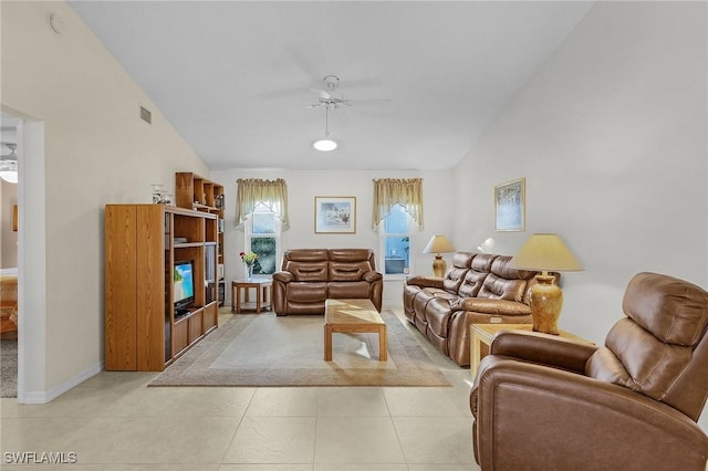 living room featuring light tile patterned flooring, ceiling fan, and vaulted ceiling