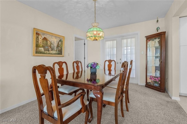 dining area with light colored carpet and french doors