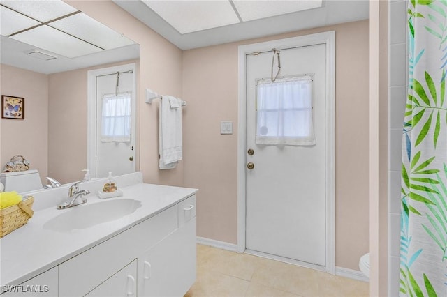 bathroom featuring vanity, a shower with curtain, tile patterned floors, and toilet