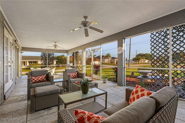 sunroom featuring ceiling fan