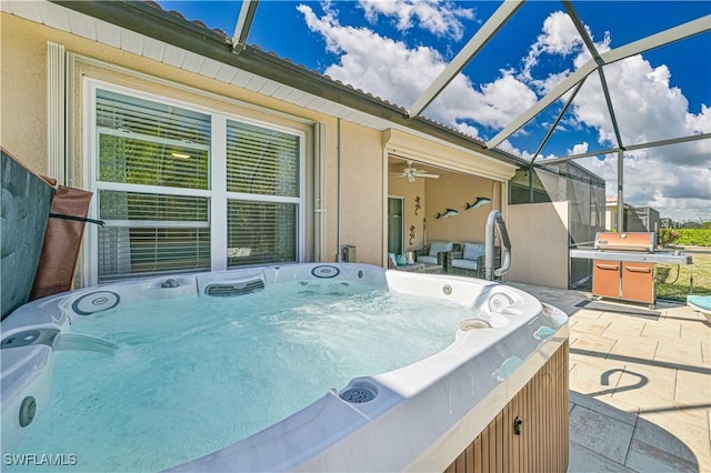 view of patio / terrace with a grill, a hot tub, washer / dryer, and glass enclosure