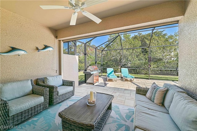 view of patio with ceiling fan, grilling area, an outdoor living space, and a lanai