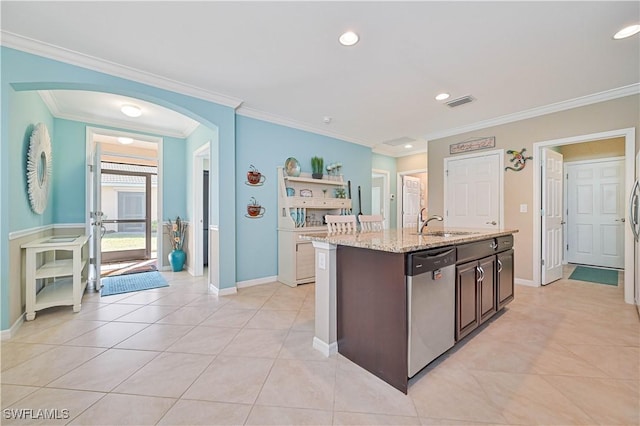 kitchen featuring sink, dishwasher, dark brown cabinetry, light stone counters, and a center island with sink