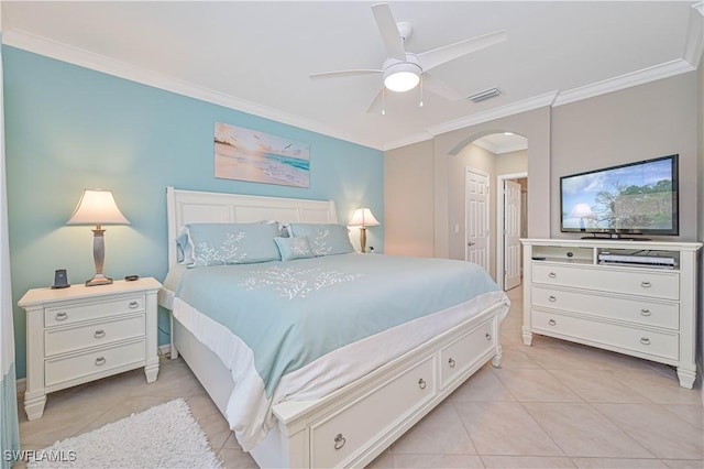 bedroom featuring ensuite bath, ornamental molding, ceiling fan, and light tile patterned flooring