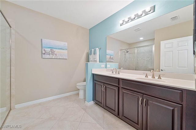 bathroom featuring tile patterned flooring, toilet, vanity, and a shower with shower door