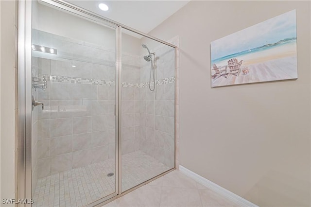 bathroom featuring an enclosed shower and tile patterned floors