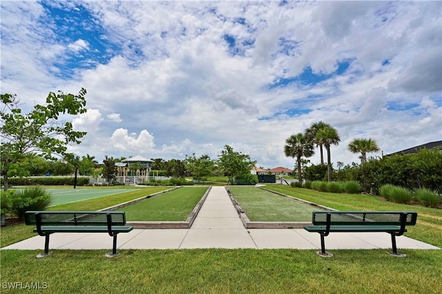 view of property's community with a yard